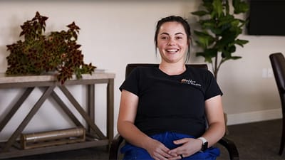 Staff member smiling in a lounge area