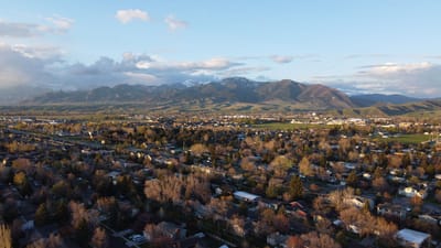 Aerial view of a suburban area with mountains in the background