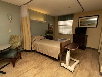 Private resident room with bed and seating area
