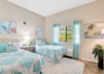Brightly decorated shared resident room with two beds