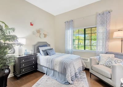 Cozy private resident room with a bed and seating area