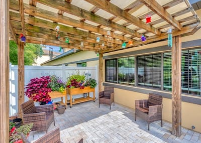 Outdoor seating area with plants under a pergola