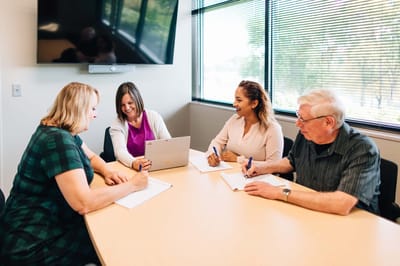 Staff members collaborating in a meeting room