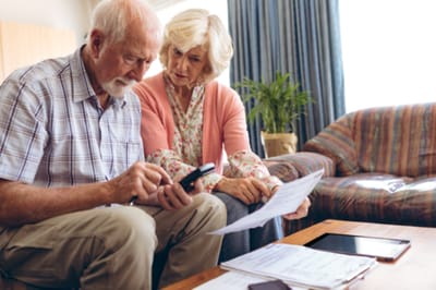 Couple discussing paperwork in a cozy living area