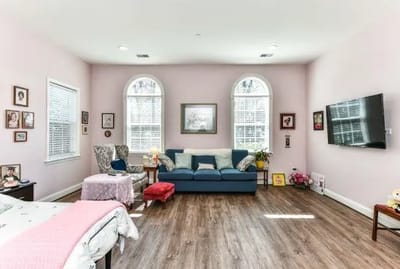 Bright and cozy resident room with a sofa and decor