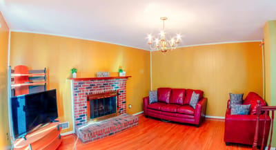 Cozy living room with red sofas and a fireplace