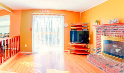Bright and inviting common area with a TV and fireplace