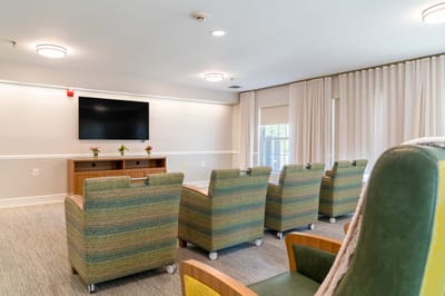 A bright common area with seating and a television