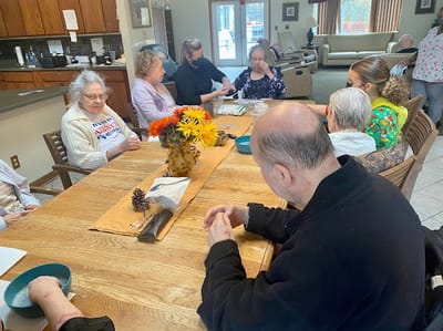 Residents engaged in an activity around a table
