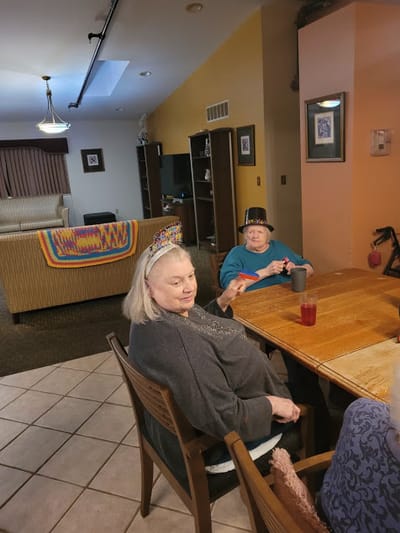 Residents celebrating at a table in a common area