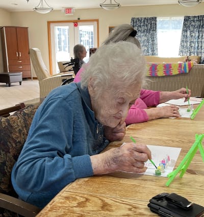 Residents engaging in a creative activity in the common area
