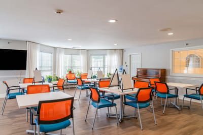 Bright activity room with colorful chairs and plants