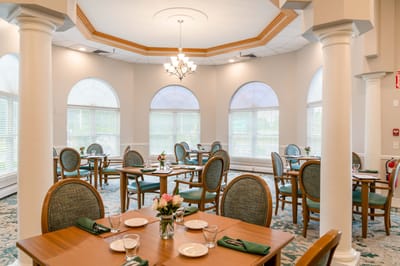 Bright dining room with tables set for meals