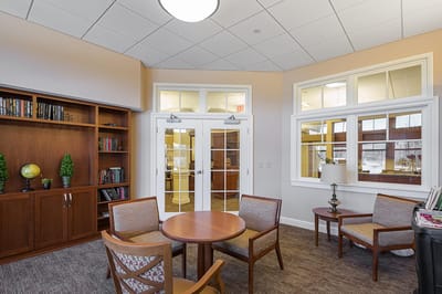 Bright common area with seating and bookshelves