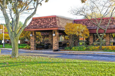 Exterior view of The Arbor Inn with fall foliage