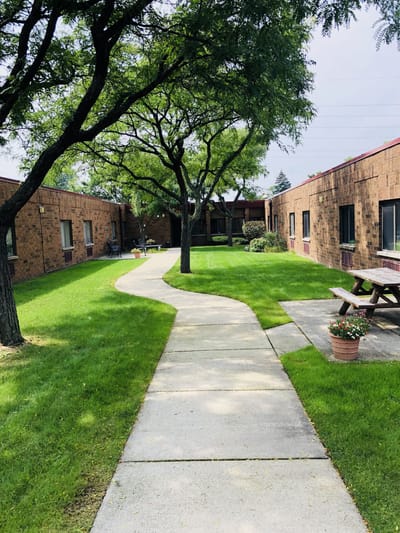 Pathway through landscaped outdoor area of a facility