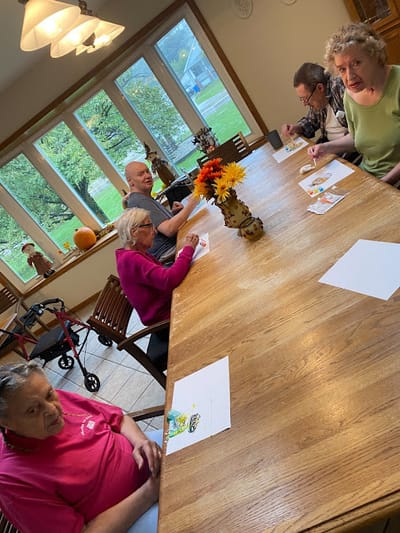 Residents engaged in a group activity at a communal table