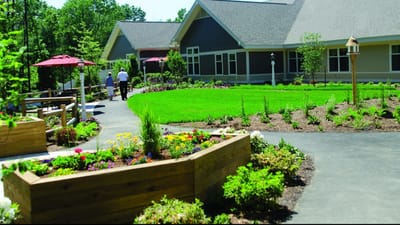 Residents walking through a landscaped outdoor area