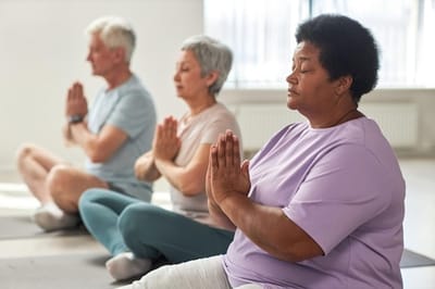 Residents participating in a yoga class indoors