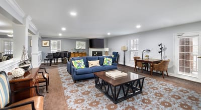 A cozy common area with seating and a piano