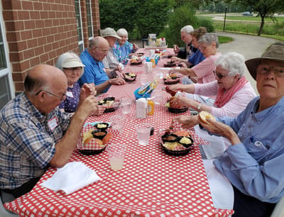Residents enjoying a meal at an outdoor table