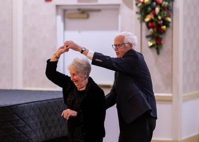 Residents enjoying a dance together at a festivities event.
