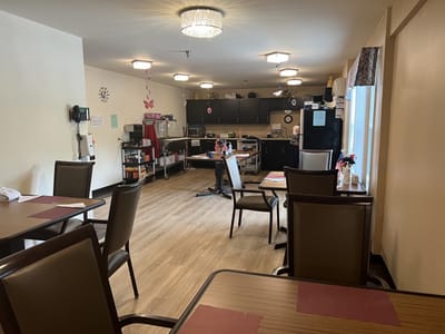 Dining area with tables and kitchen appliances