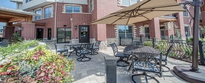 Outdoor seating area with tables and umbrellas