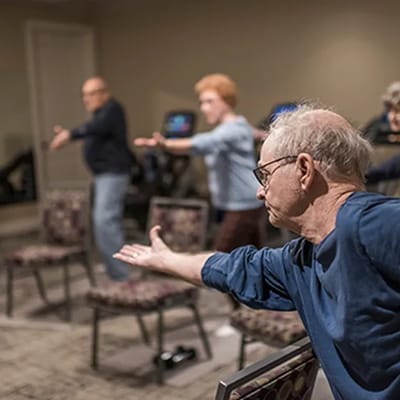 Residents participating in a seated exercise class
