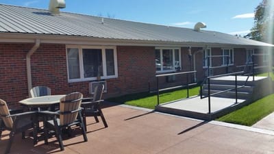 Outdoor seating area with tables and accessible walkway