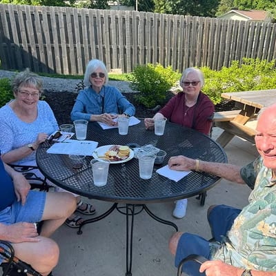 Residents enjoying snacks at an outdoor table