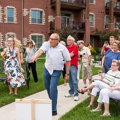 Residents enjoying an outdoor activity in a landscaped courtyard