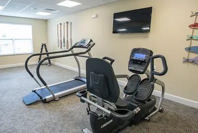 Fitness area with exercise equipment and televisions