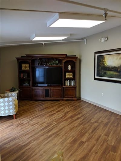 An interior common area with a wooden cabinet and TV