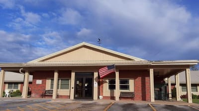 Exterior view of Jefferson City Manor with American flag