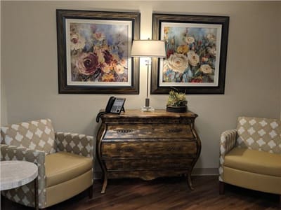Cozy corner with armchairs and floral artwork