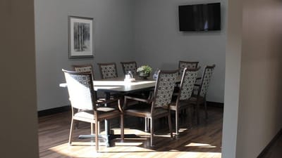 Interior view of a meeting room with a large table and chairs