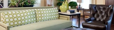 Bright lounge area with a couch and armchair