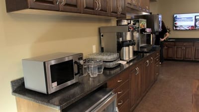 A kitchen area with coffee and snacks available