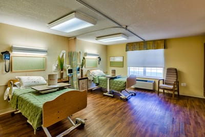 A cozy resident room with two adjustable beds