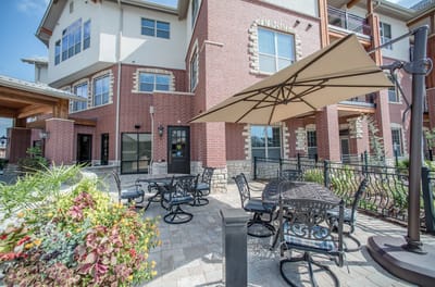 Outdoor seating area with tables and umbrellas