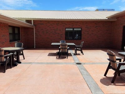 Outdoor patio area with tables and chairs