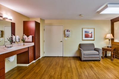 Private room in a senior living facility with comfortable furnishings