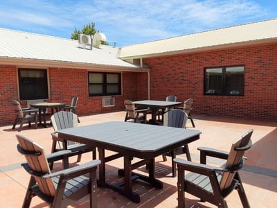 Outdoor seating area with tables and chairs