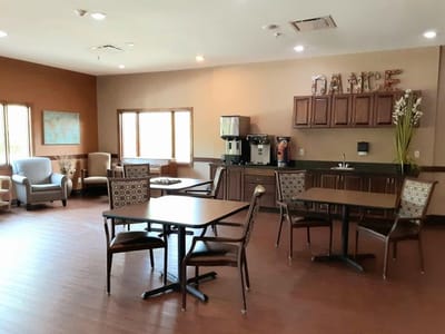 Bright common area with seating and a snack station