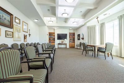 Bright common area with seating and shelves.