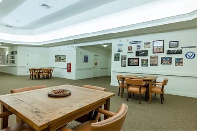 Common area with tables and chairs, decorated walls