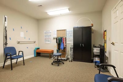 Empty therapy room with equipment and seating