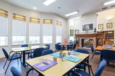 Art activity in a bright common area with tables and chairs