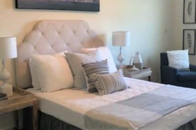 Brightly furnished resident room with bed and seating